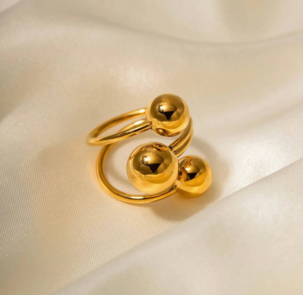 Anello BEHI MIA donna con tre sfere lucide in acciaio placcato oro 18k su tessuto chiaro, design moderno