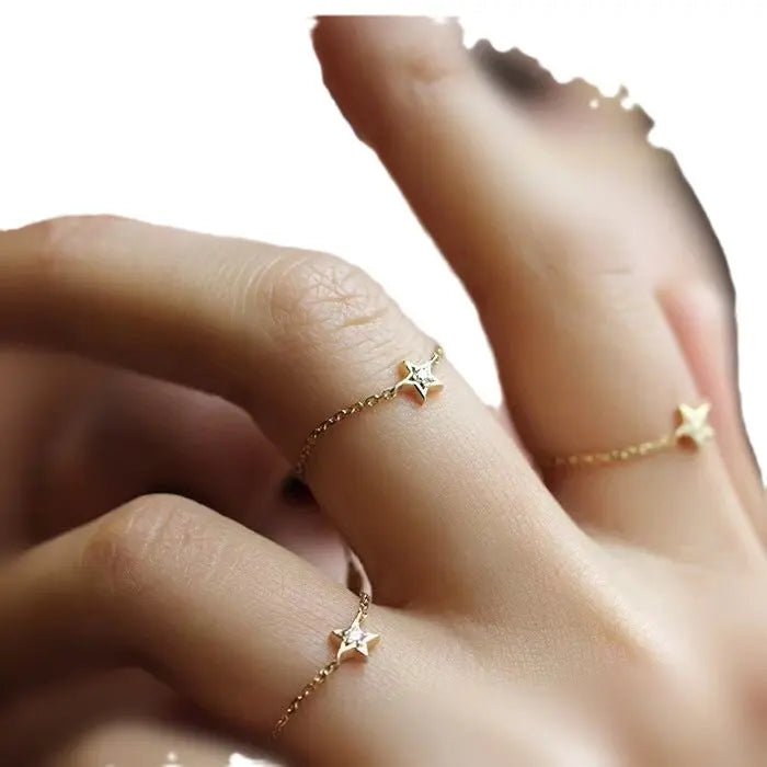 Anello Stella regolabile in oro 18K con catena, diamanti, su dito di donna. Gioiello raffinato.