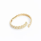 Bracciale rigido wrap oro 18k con motivo floreale bianco e dorato, design italiano