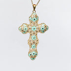 Collana croce MINA MINA in Argento 925 placcato oro 18k, smalto turchese e strass neri, sfondo bianco.