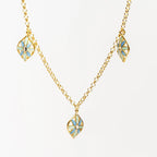 Collana multifoglie 'Leaf Me' in argento 925 placcato oro 18k con ciondoli smaltati azzurro e blu, sfondo bianco